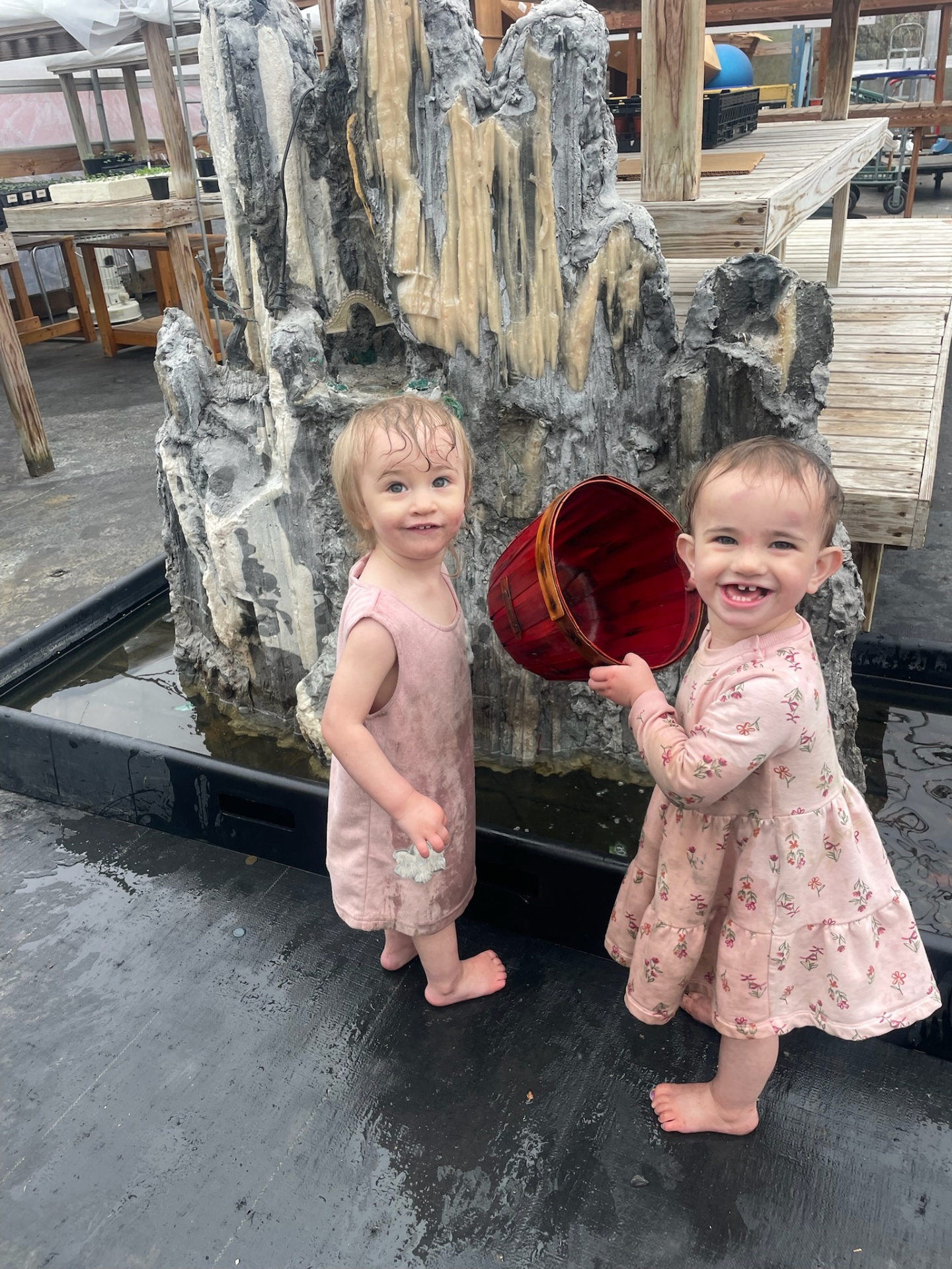 Two of our youngest playing by the greenhouse fountain